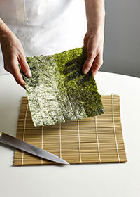 Fold nori sheets in half lengthways