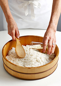 gradually pouring in the sushi vinegar