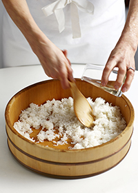 gradually pouring in the sushi vinegar