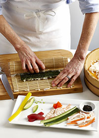 Rolling a sushi with bamboo mat