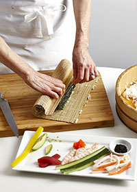 Rolling a sushi with bamboo mat