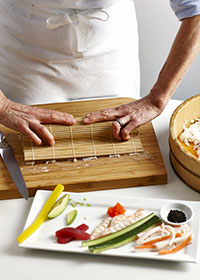 Rolling a sushi with bamboo mat