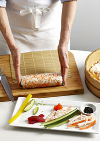 Rolling a sushi with bamboo mat