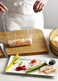 Rolling a sushi with bamboo mat